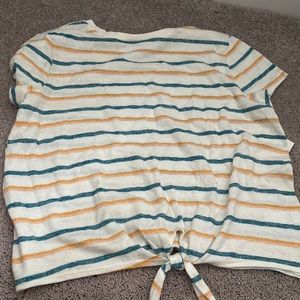 Striped shirt. Pink, yellow/orange, and blue stripes. Tie at the bottom.